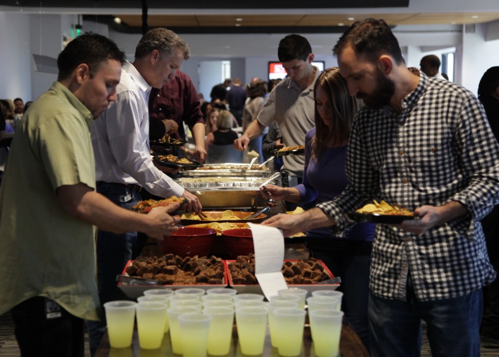 Photo: Rachael Evans Associates line up for lunch on Wednesday at Thanksgiving Tower.