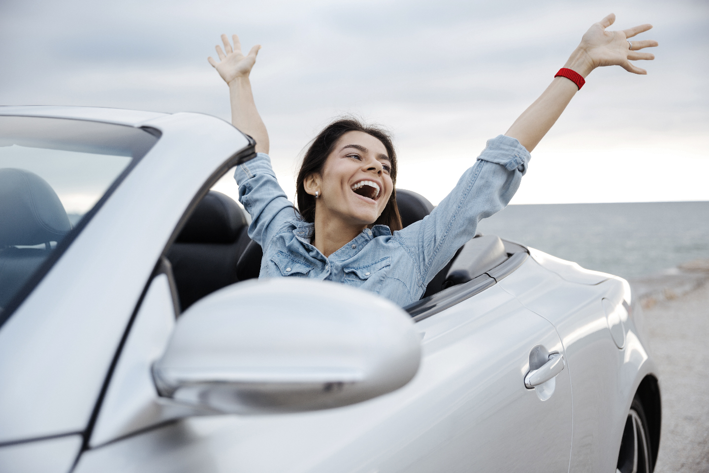 Woman celebrating in car