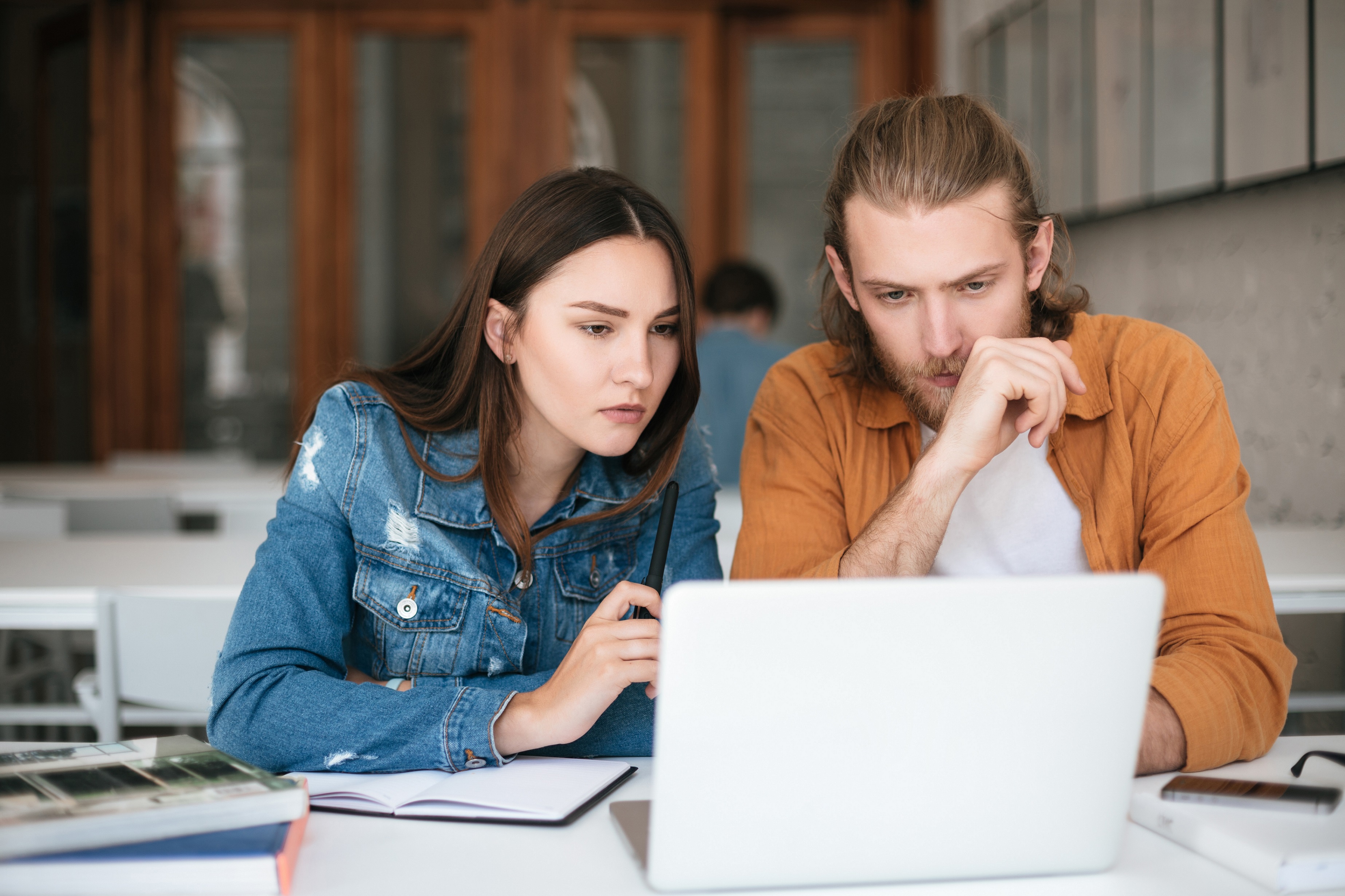 Young couple on computer paying bills