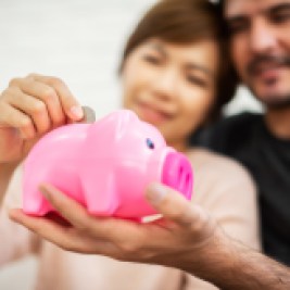 Couple saving in piggy bank