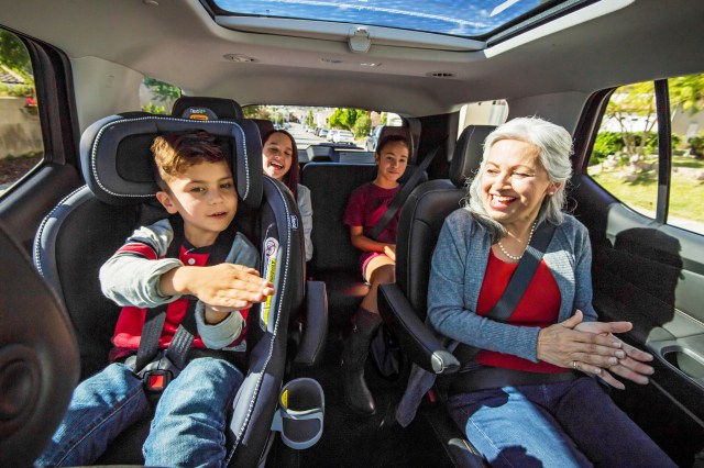 Older woman and kids in back seats