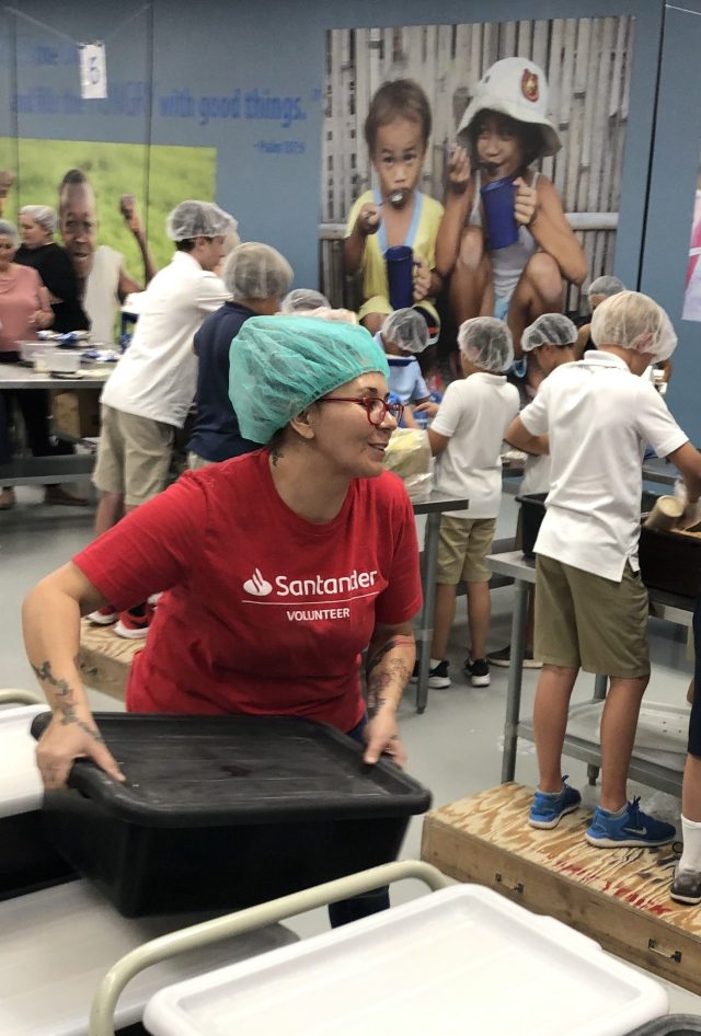 “Starving Children” volunteer moving a tub of food