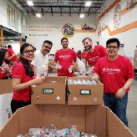 Volunteers filling boxes with water bottles