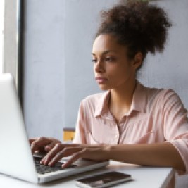 Young woman using auto-finance calculator