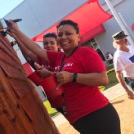 Santander volunteers painting tiny house