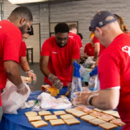 Group of volunteers making sandwiches.