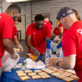 Group of volunteers making sandwiches.